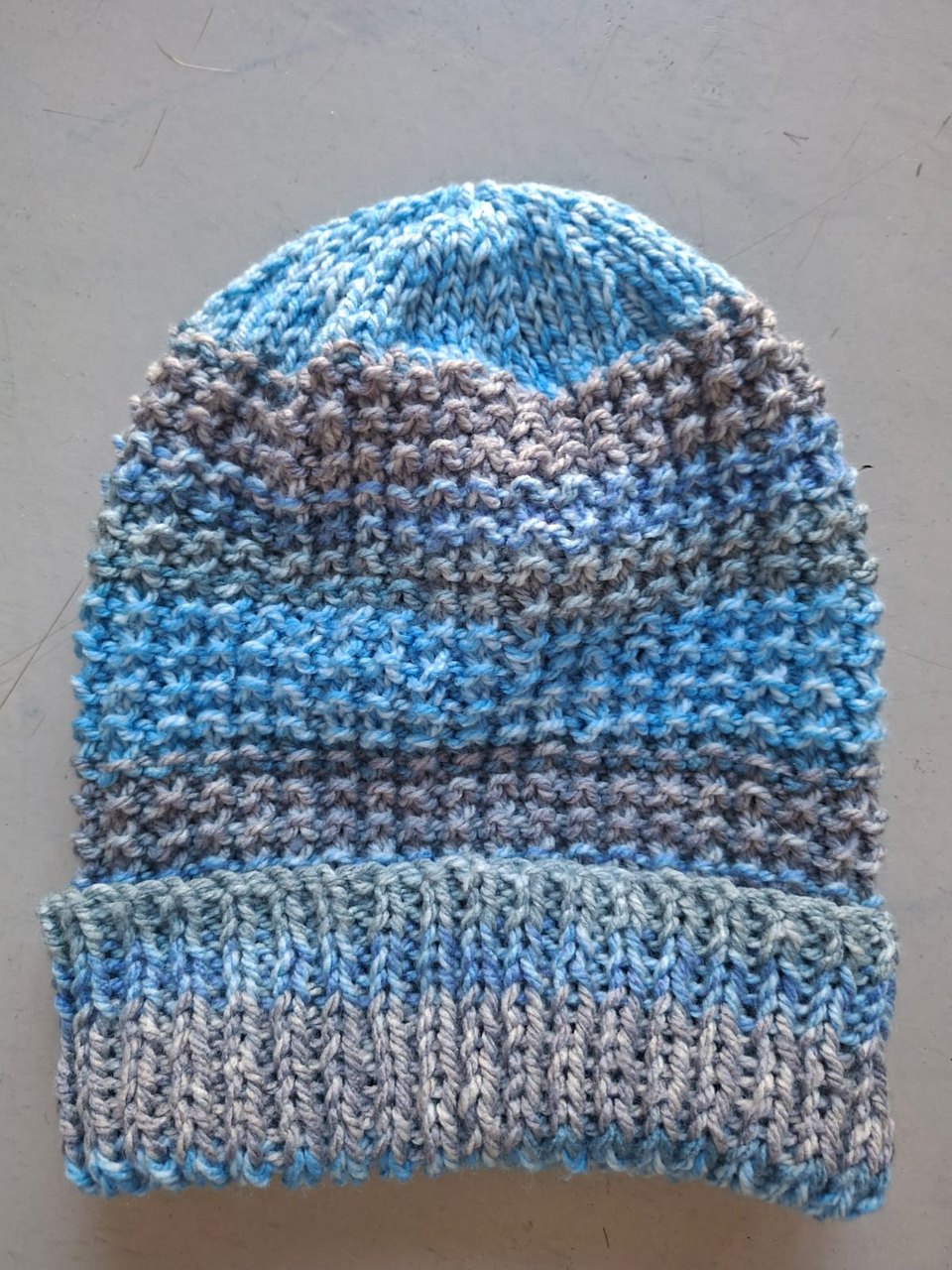 Blue, grey and teal marled beanie with a textured knit, hand-knitted at Kranshoek