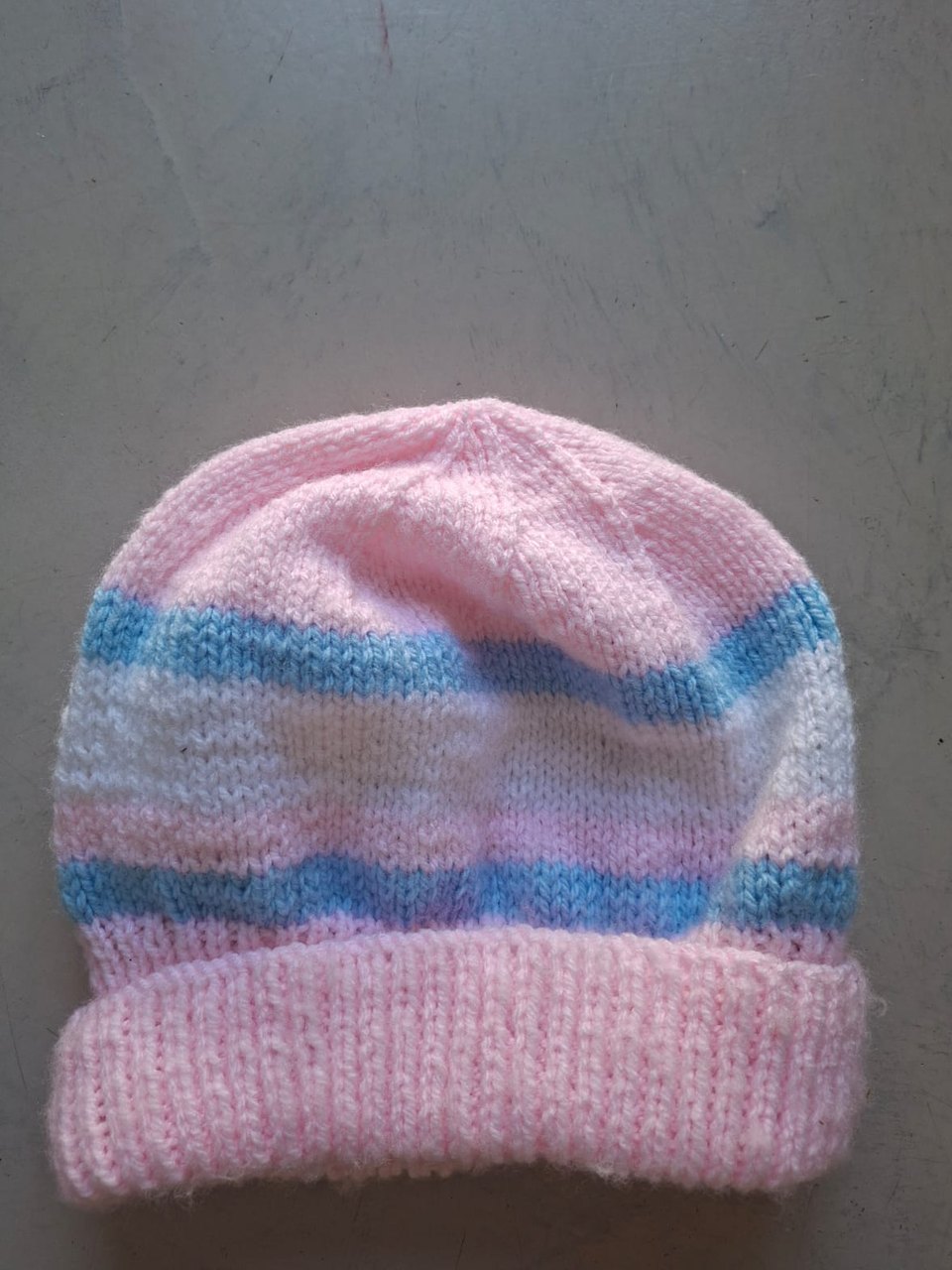 Pink beanie with pale blue stripes, hand-knitted at Kranshoek