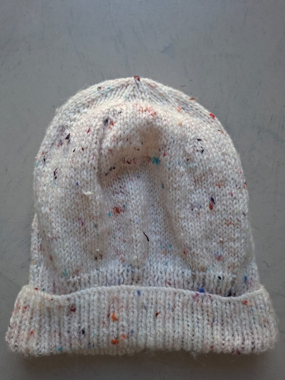 Cream flecked beanie with confetti specks, hand-knitted at Kranshoek