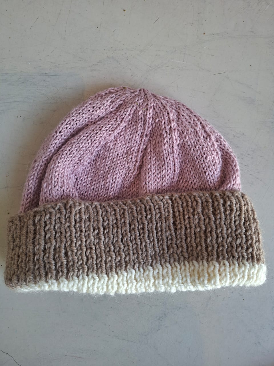 Blush pink and taupe beanie with a cream trim line, hand-knitted at Kranshoek