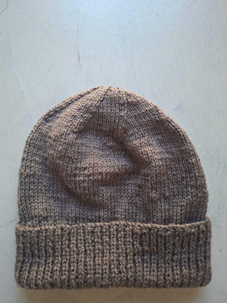 Solid taupe brown beanie with a folded rib cuff, hand-knitted at Kranshoek