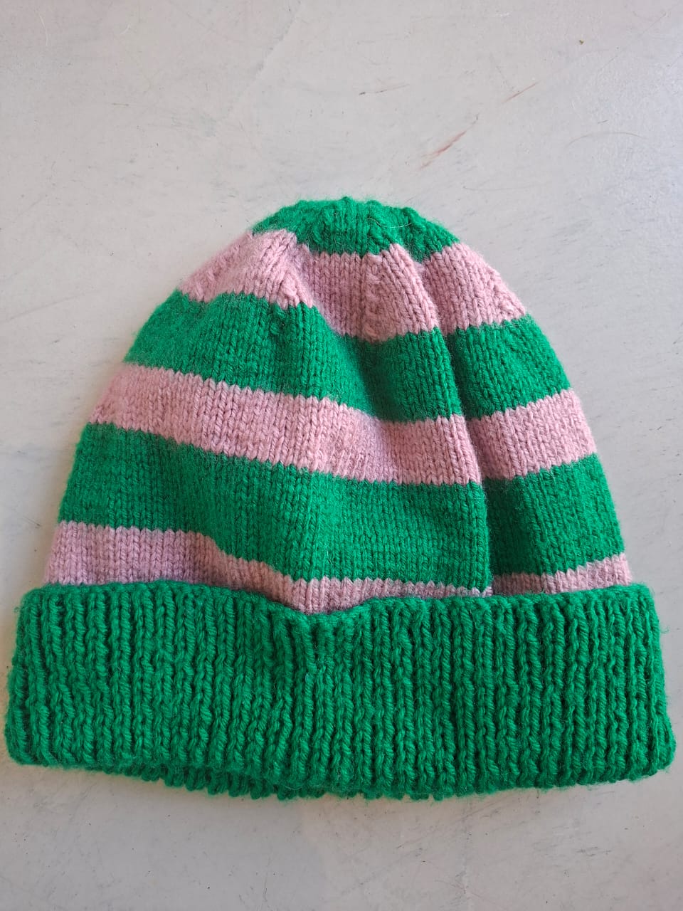 Green and pink striped beanie, hand-knitted at Kranshoek